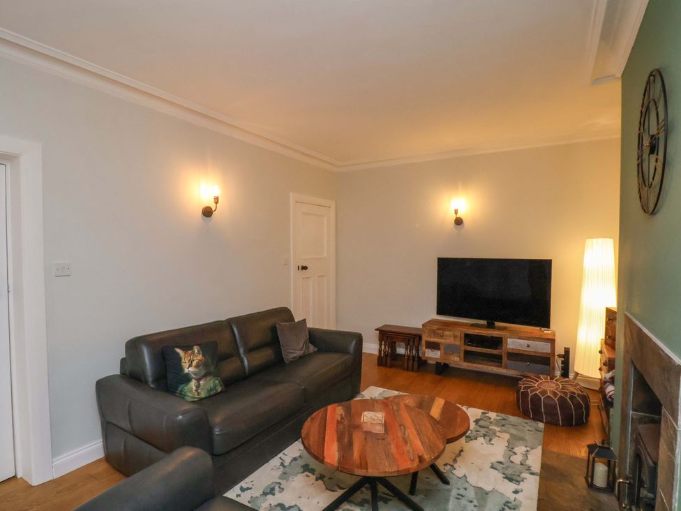 A living room with a sofa and television at Falcon's Nest in Whitby