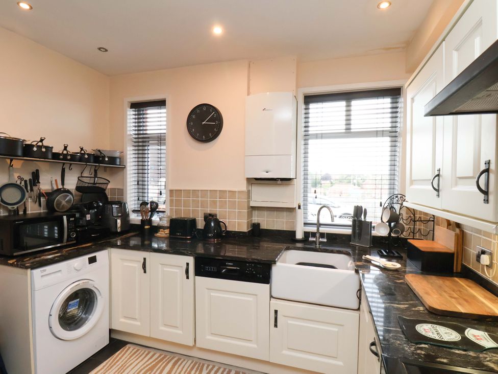 A kitchen with appliances and cabinets at Falcon's Nest in Whitby
