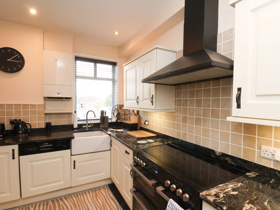 A kitchen with an oven and sink at Falcon's Nest in Whitby