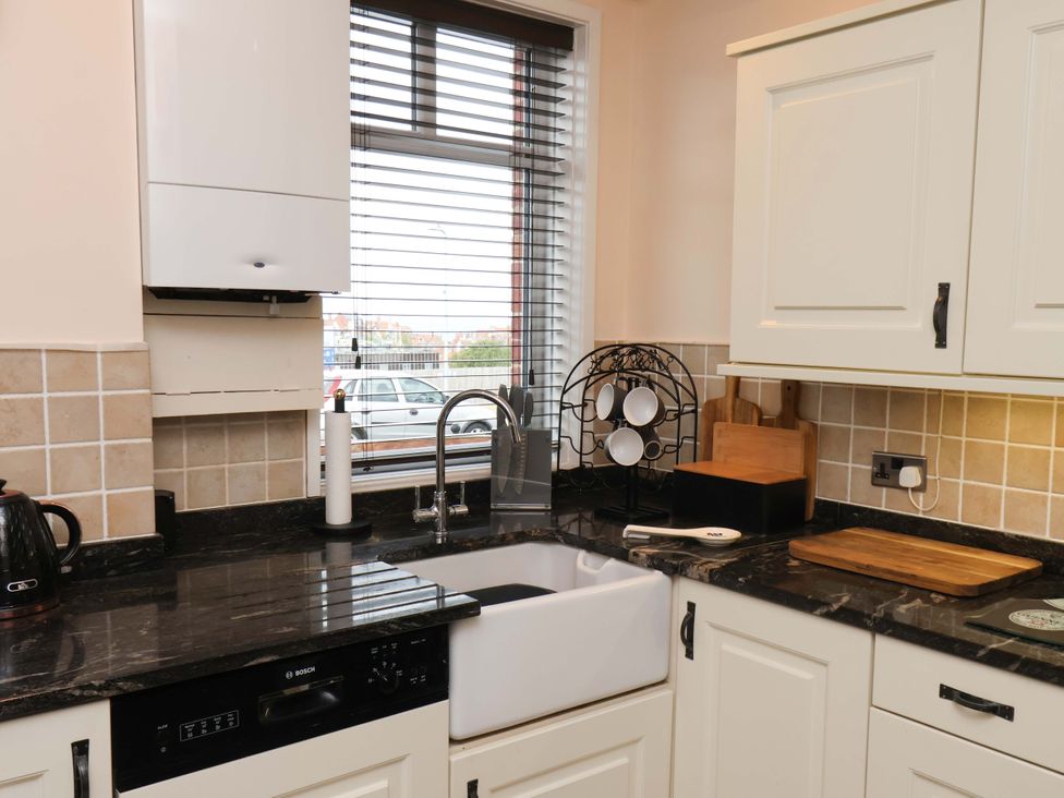A kitchen with sink and cabinets at Falcon's Nest in Whitby