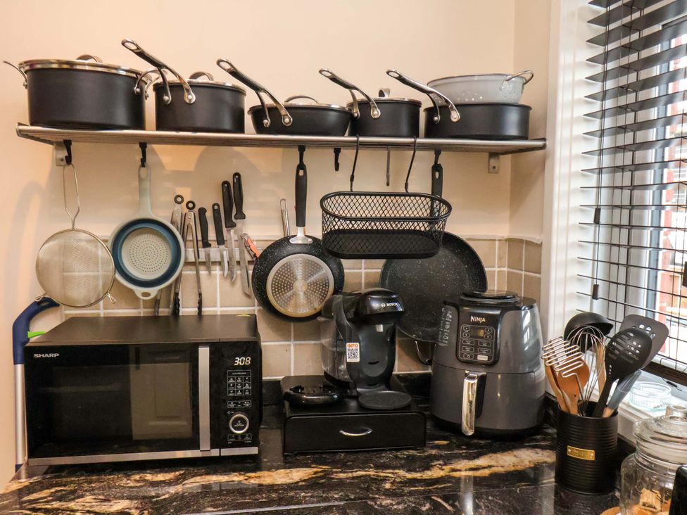 A kitchen with pots and kitchen appliances at Falcon's Nest in Whitby