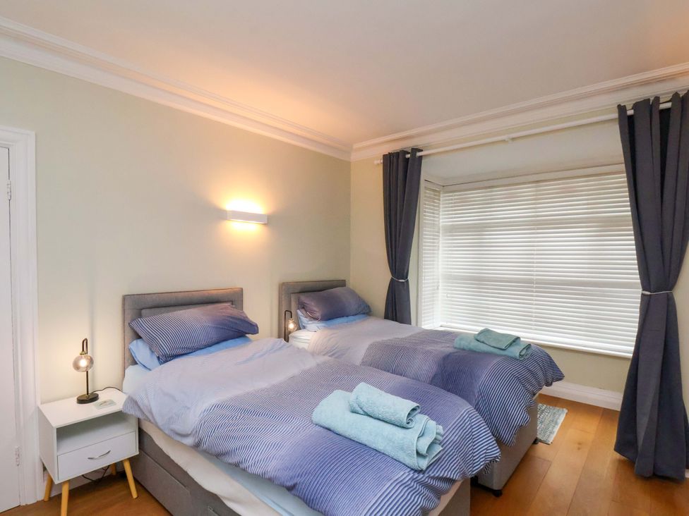 A bedroom with two beds and a window at Falcon's Nest in Whitby