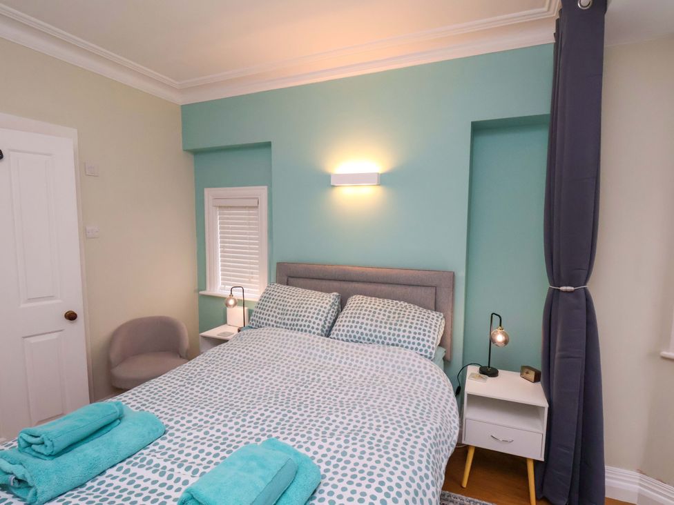 A bedroom with a bed and a side table at Falcon's Nest in Whitby