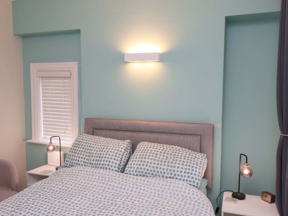 A bedroom with a bed and bedside lamps at Falcon's Nest in Whitby