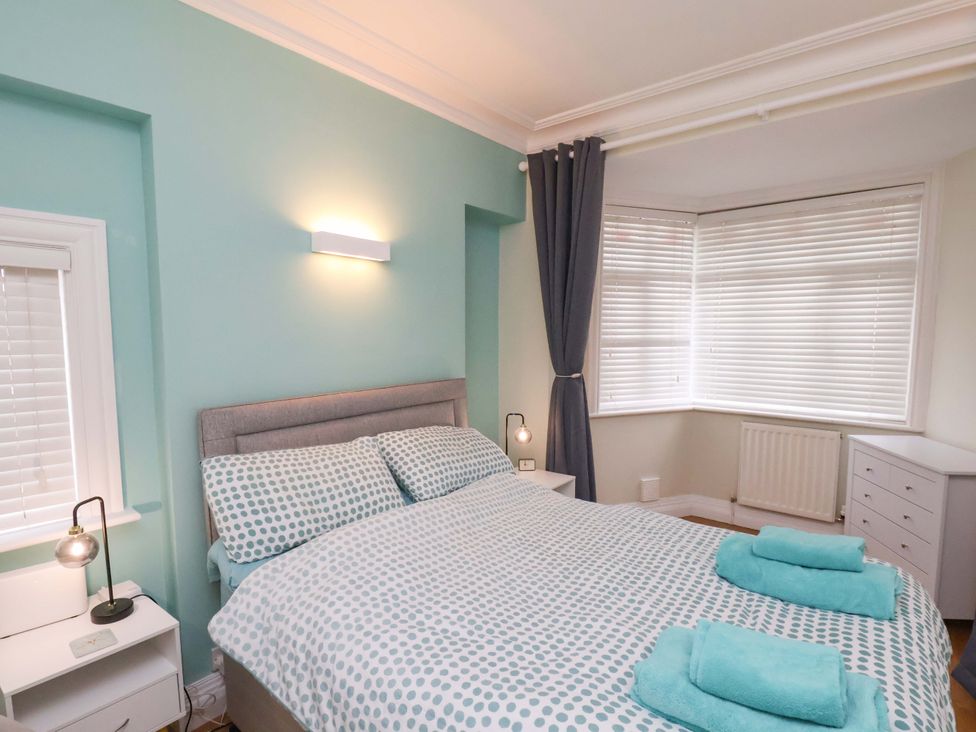 A bedroom with a bed and nightstand at Falcon's Nest Whitby