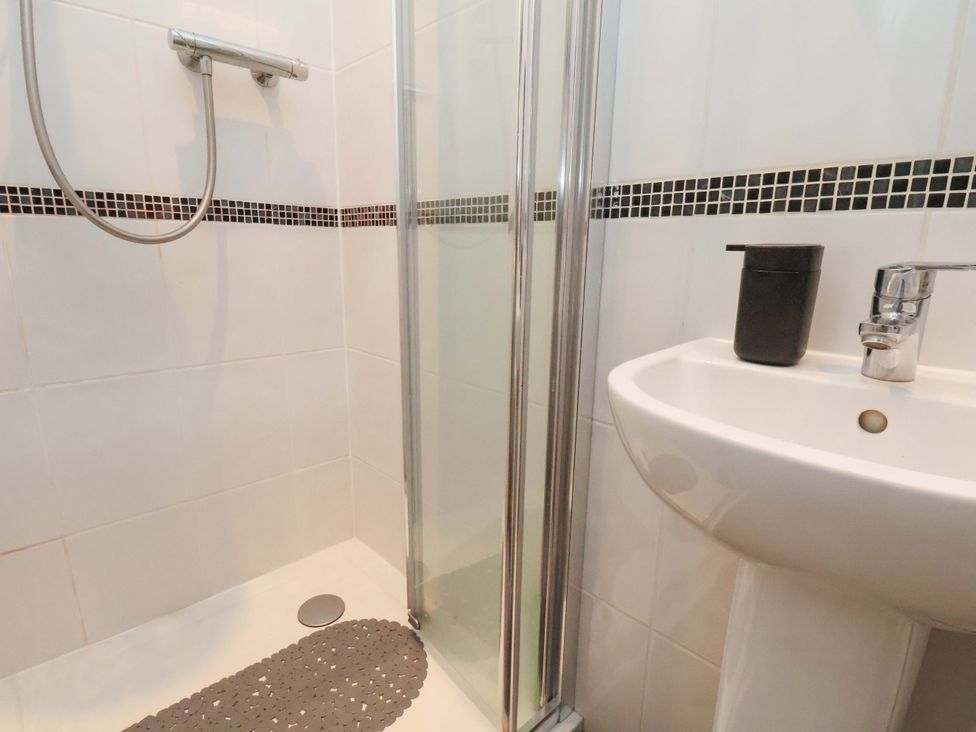 A bathroom with a shower and sink at Falcon's Nest in Whitby