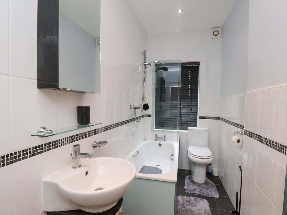A bathroom with a bath tub and shower at Falcon's Nest in Whitby