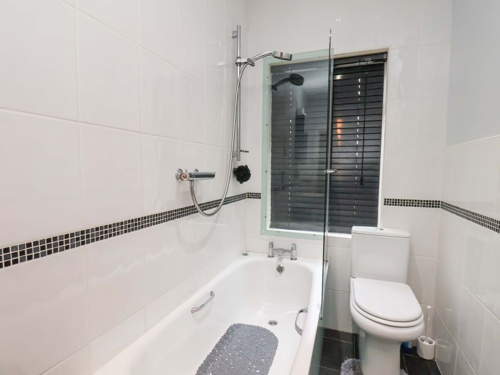 A bathroom with a bathtub and shower at Falcon's Nest in Whitby