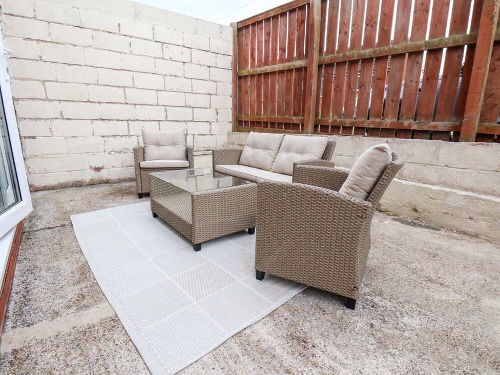 An outdoor lounge area with seating and a table at Falcon's Nest in Whitby