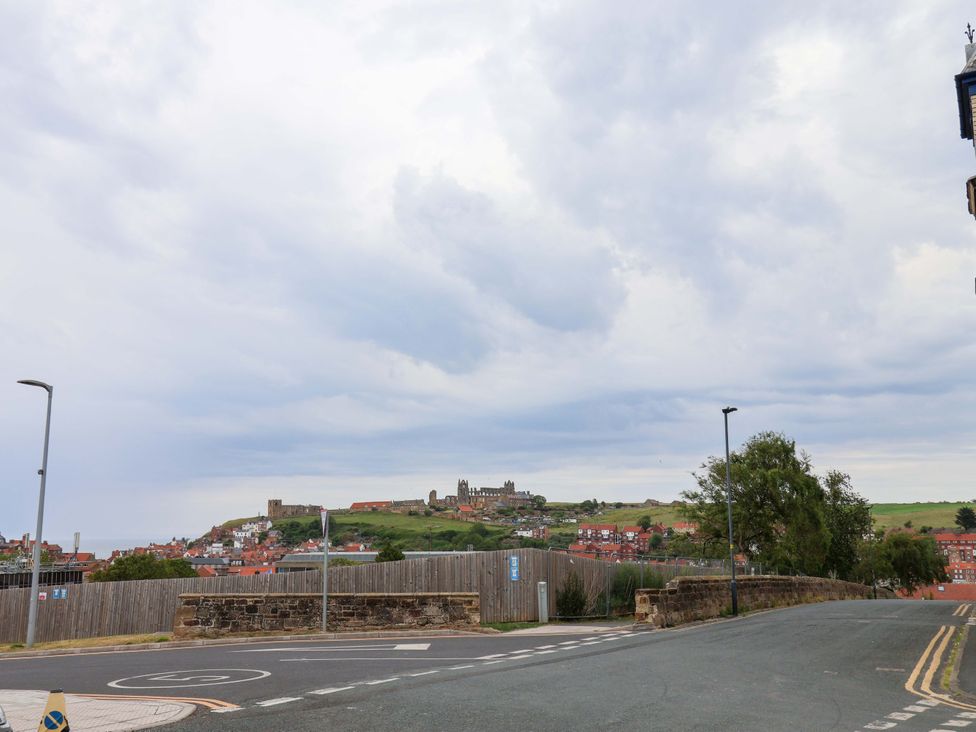 A street view with surrounding buildings and a castle at Falcon's Nest in Whitby