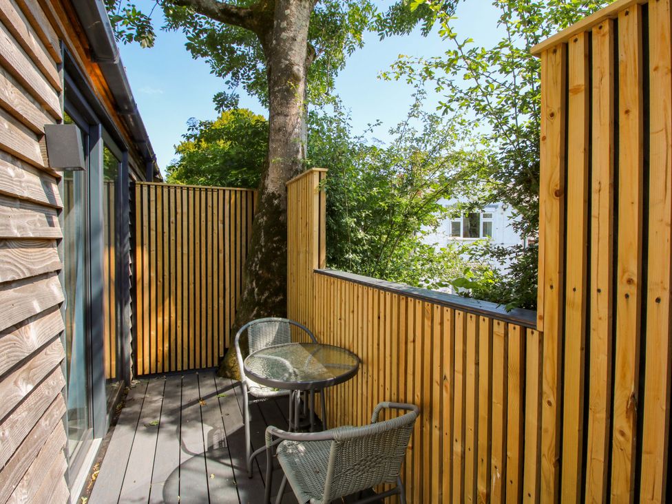 A balcony with a table and chair at Stiper View Barn 1 in Gravels Bank