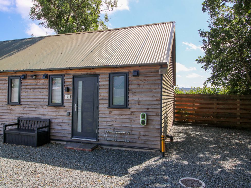A cabin with a bench and electric charger at Stiper View Barn 2 Gravels Bank