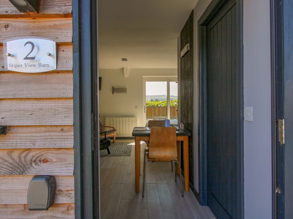 An entrance with a table and chair at Stiper View Barn 2 Gravels Bank