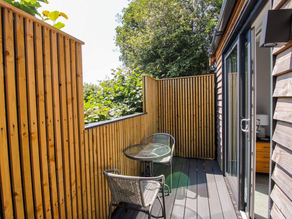 A deck with a table and chairs at Stiper View Barn 2 Gravels Bank