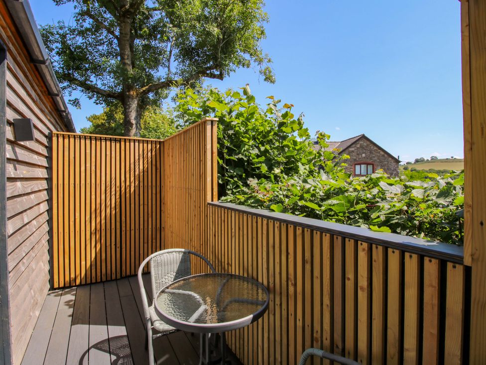 A balcony with a table and chairs at Stiper View Barn 2 Gravels Bank