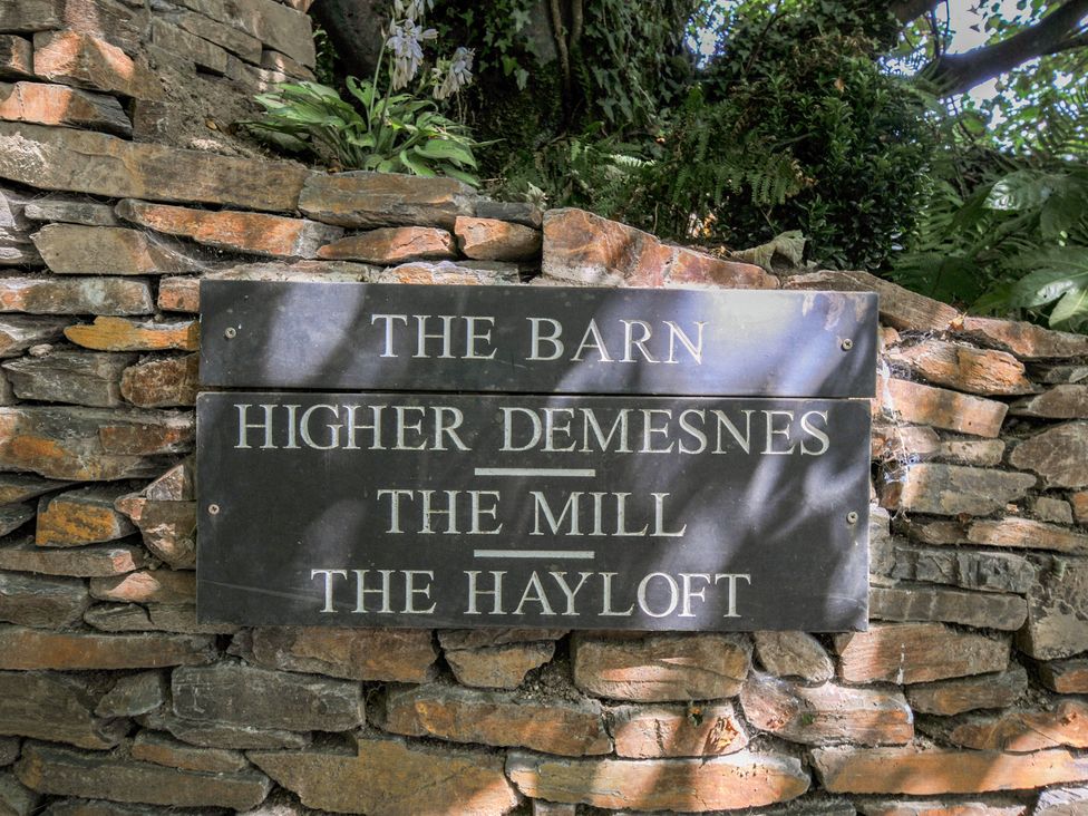 A sign displaying the names of properties at The Hayloft in Lostwithiel