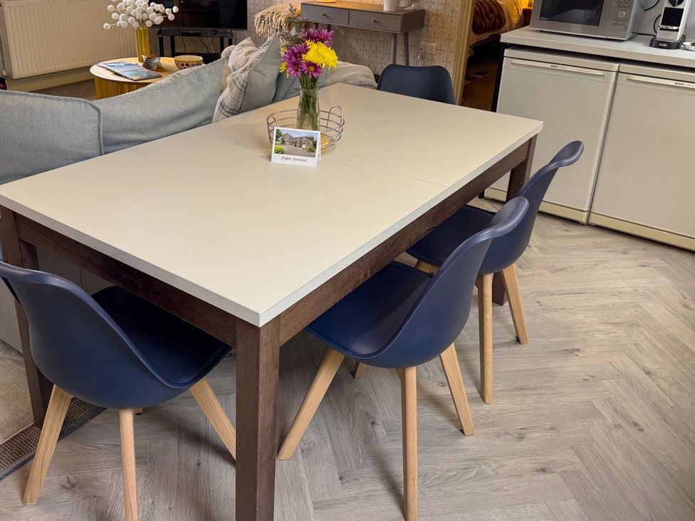 A dining room with a table and chairs at The Hayloft in Lostwithiel