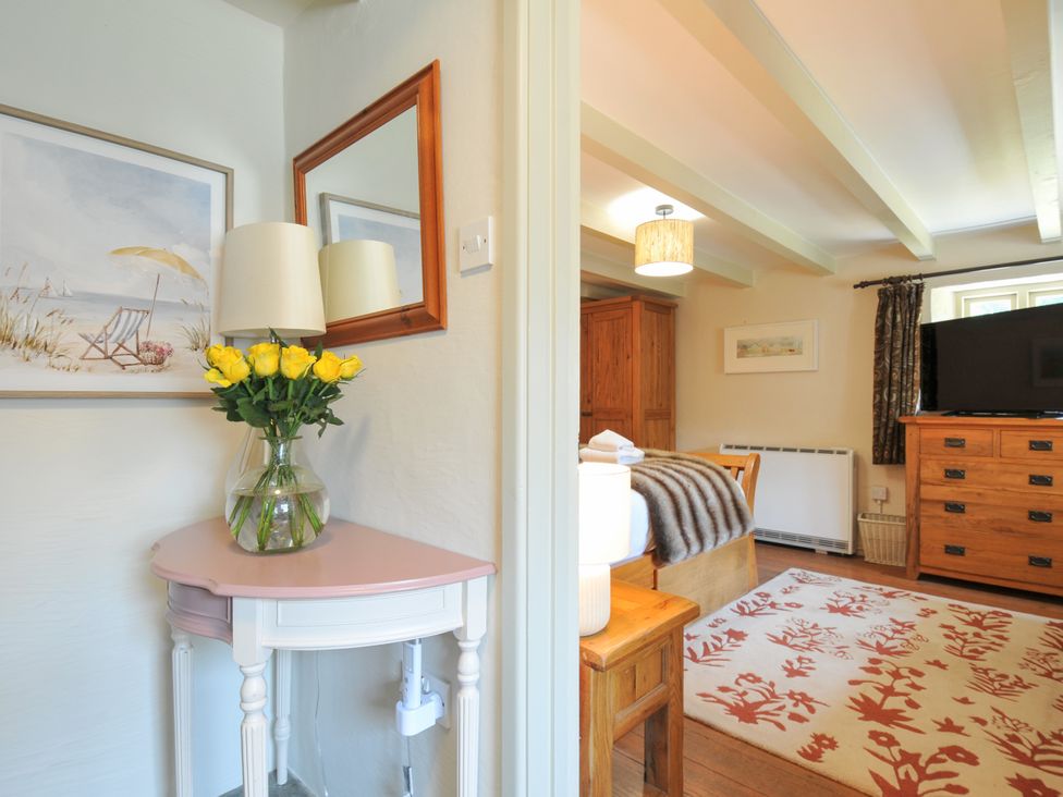 A bedroom with furniture and decor at The Mill in Lostwithiel