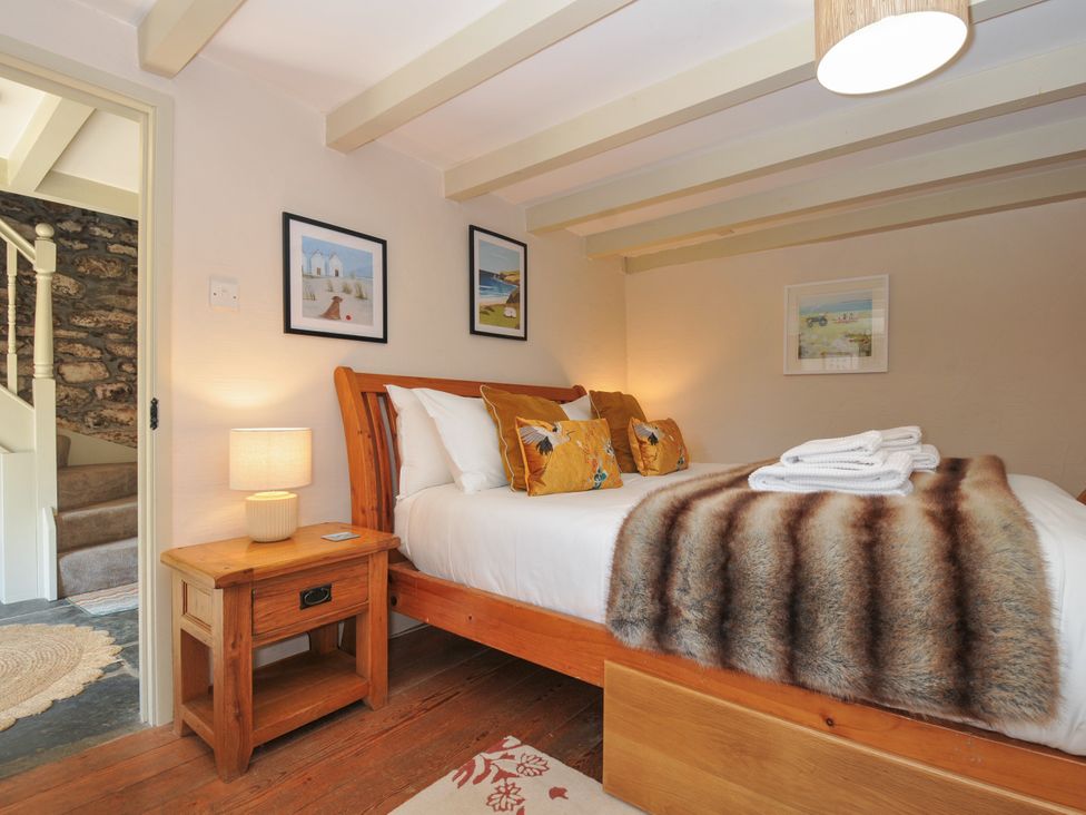 A bedroom with a bed and bedside table at The Mill in Lostwithiel