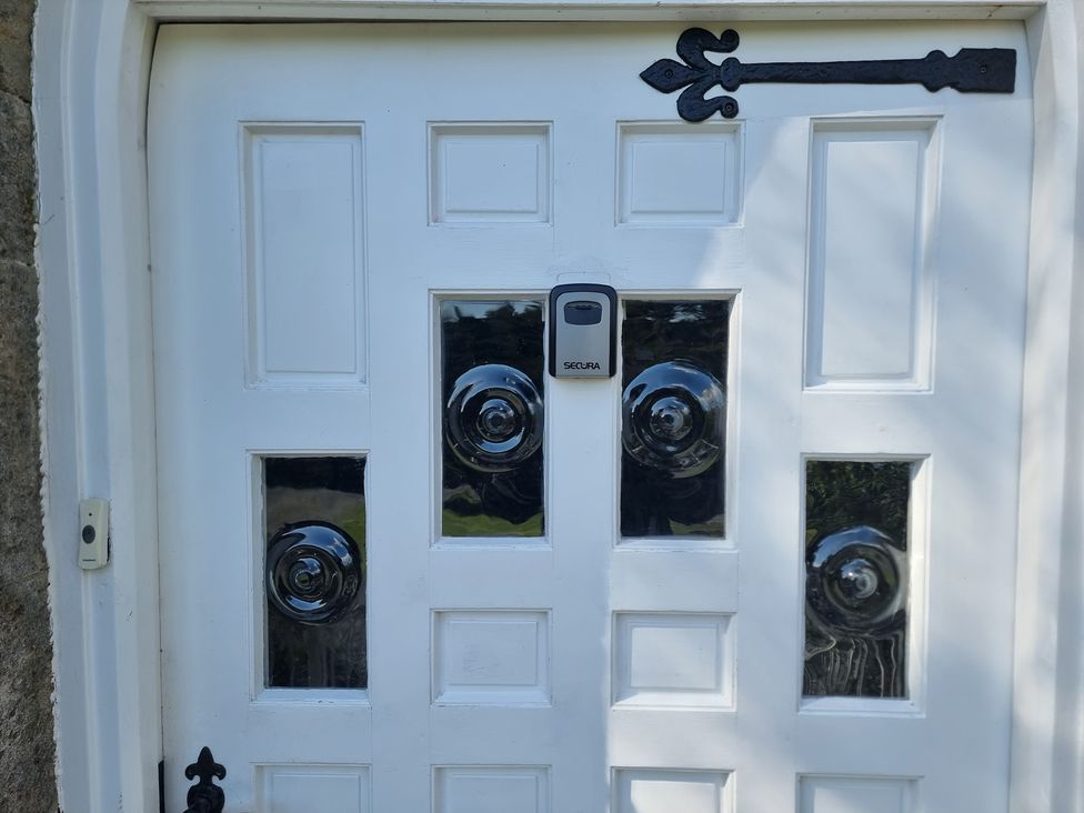 A front door with glass panels and a security device at Ashleigh House
