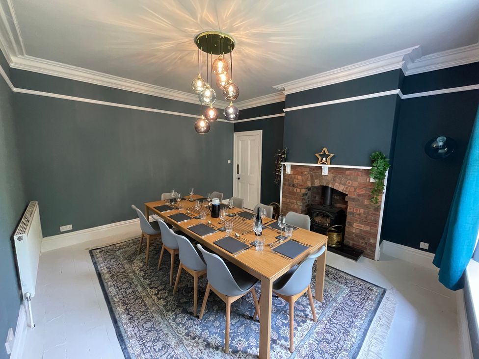 A dining room with a table, chairs, and a fireplace at Montclair