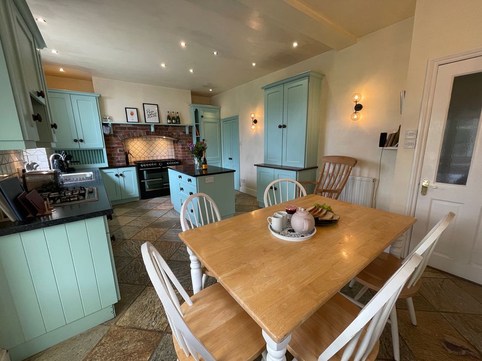 A kitchen with a table and chairs at Montclair