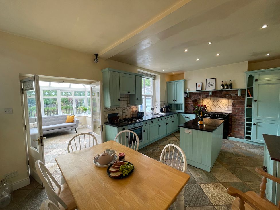 A kitchen with dining table and cabinets at Montclair