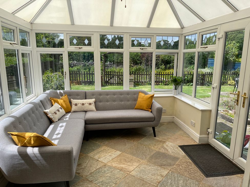 A conservatory with a sofa and plant at Montclair