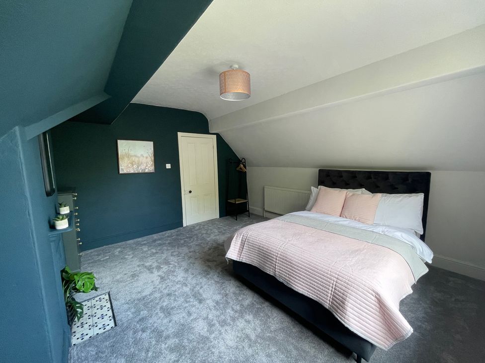A bedroom with a bed and chair at Montclair