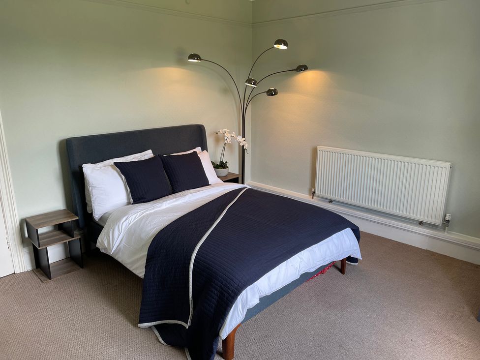 A bedroom with a bed and lamps at Montclair
