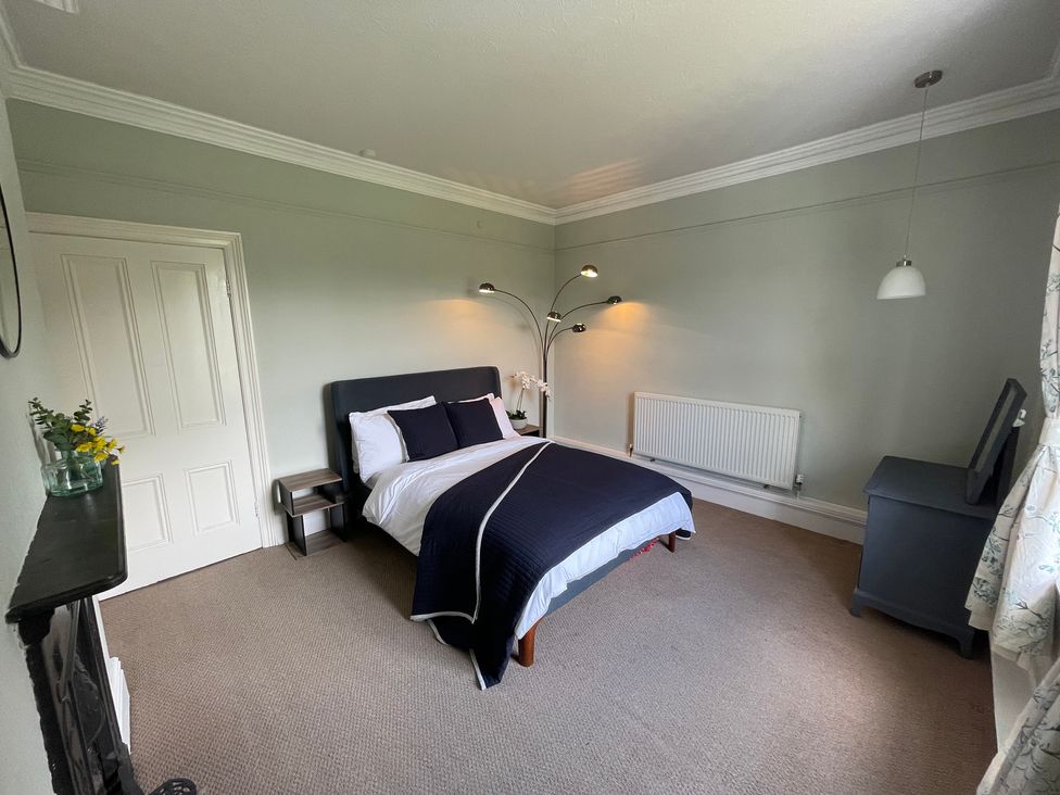 A bedroom with a bed and nightstand at Montclair