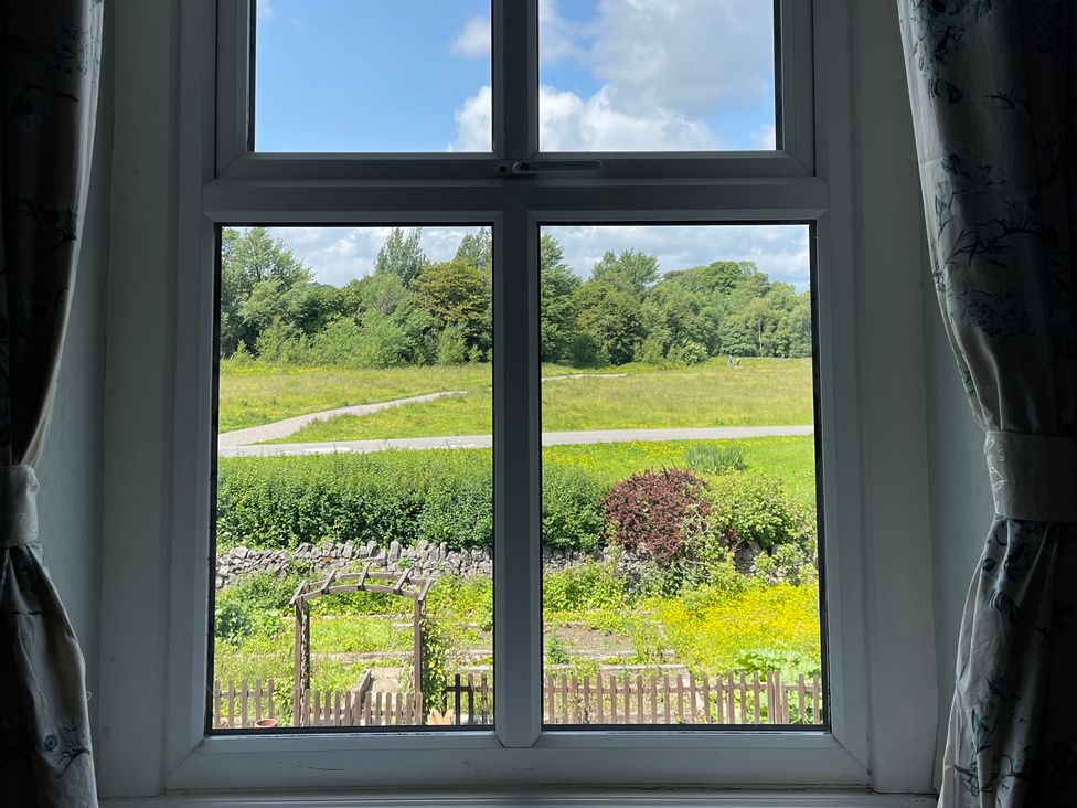 View from a window looking over a field and path at Montclair