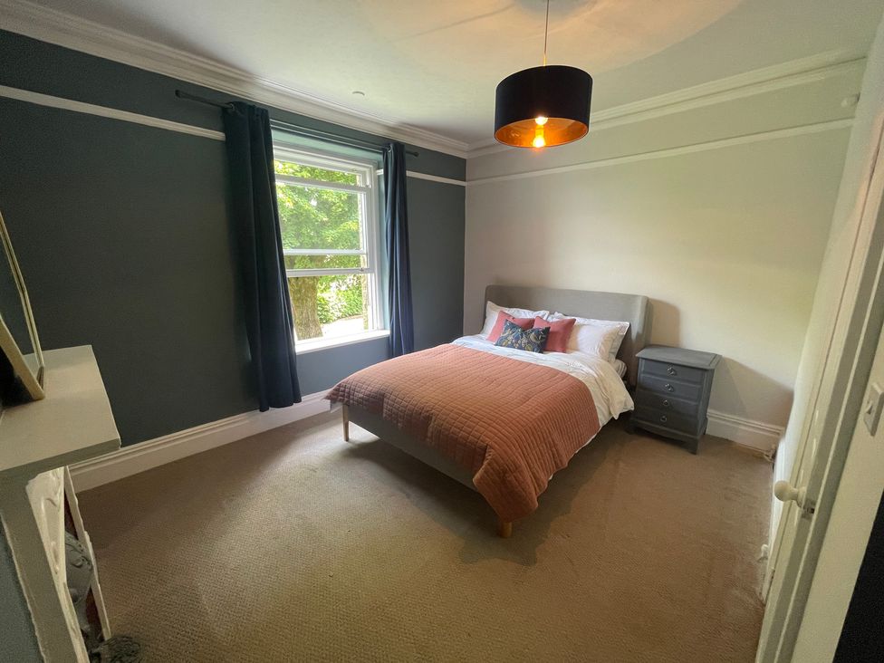 A bedroom with a bed and a nightstand at Montclair