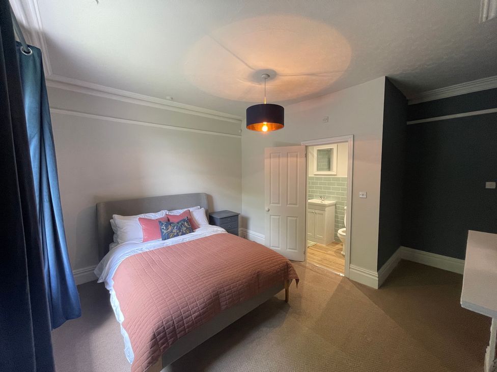 A bedroom with a bed and an adjoining bathroom at Montclair