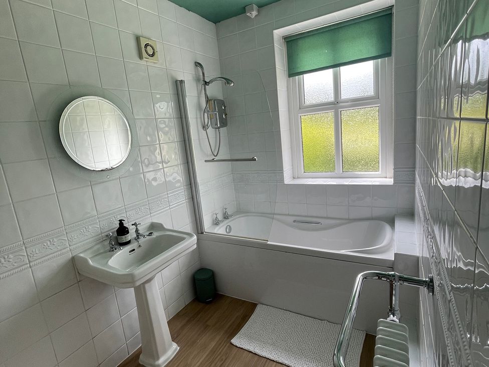 A bathroom with a bath and sink at Montclair 
