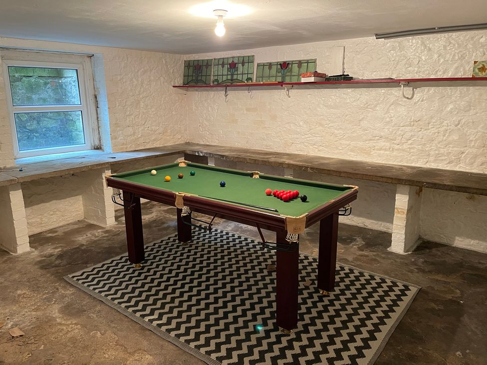 A game room with a pool table and shelves at Montclair