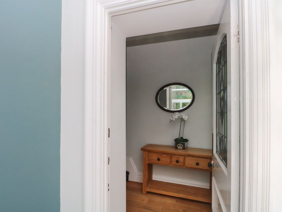 A hallway with a console table and a mirror at Montclair in Buxton