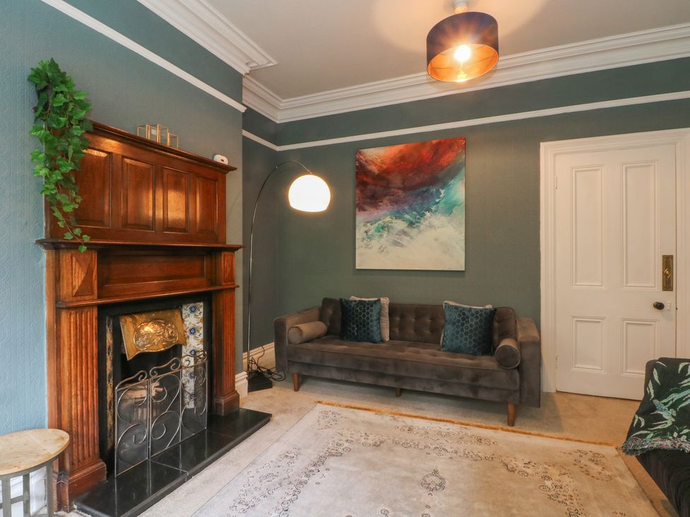 A living room with a fireplace and sofa at Montclair in Buxton