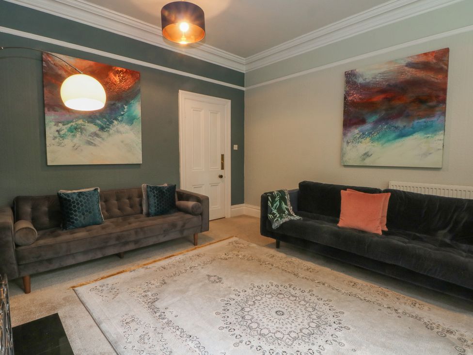 A living room with two sofas and paintings at Montclair in Buxton