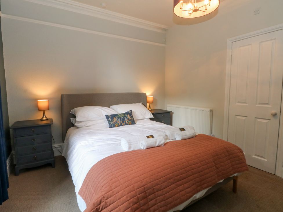 A bedroom with a bed and nightstand at Montclair in Buxton