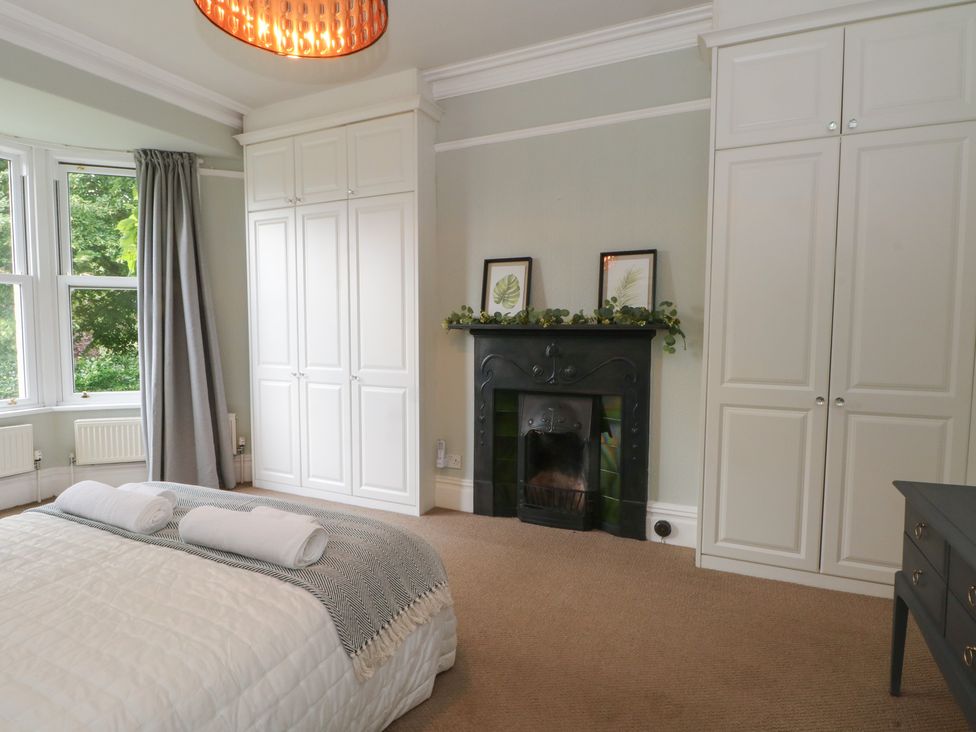 A bedroom with a bed and wardrobe at Montclair in Buxton