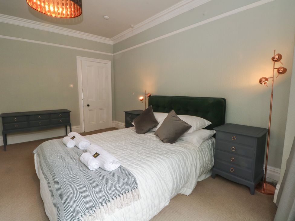 A bedroom with a bed and nightstand at Montclair in Buxton