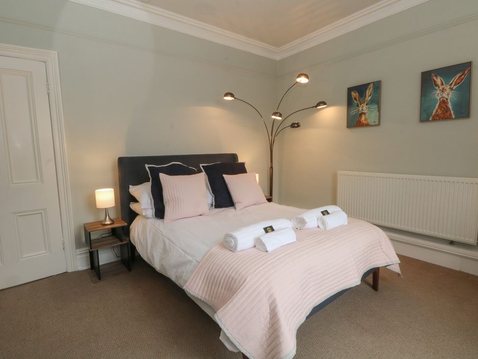 A bedroom with a bed and side table at Montclair in Buxton