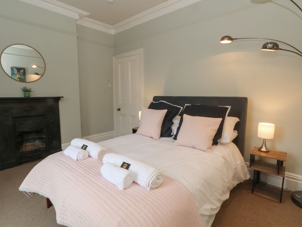 A bedroom with a bed and lamp at Montclair in Buxton