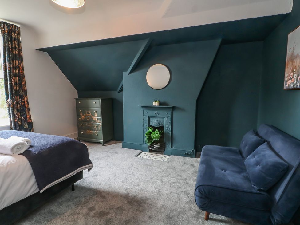 A bedroom with a bed and a sofa at Montclair in Buxton