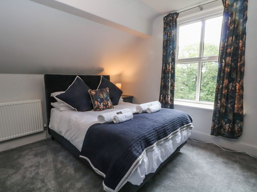 A bedroom with a bed and window at Montclair in Buxton