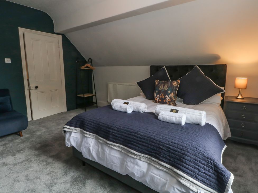 A bedroom with a bed and towels at Montclair in Buxton