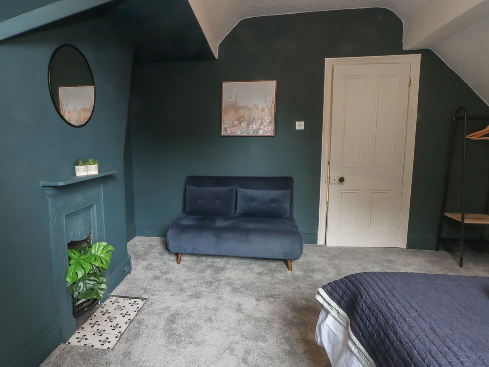 A bedroom with a couch and a plant at Montclair in Buxton