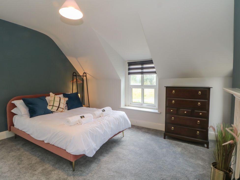 A bedroom with a bed, dresser, and window at Montclair in Buxton