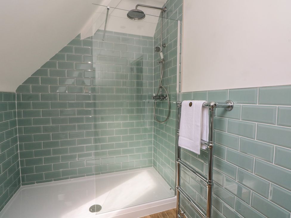 A bathroom with a shower and towel rack at Montclair in Buxton